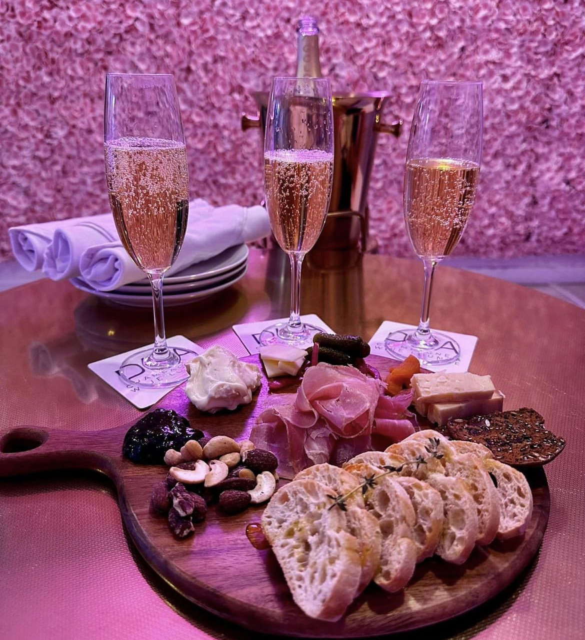 Charcuterie board paired with 3 glasses of champagne