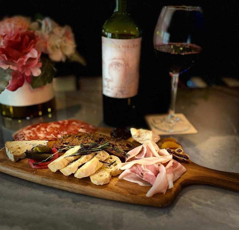 Charcuterie board paired with red wine